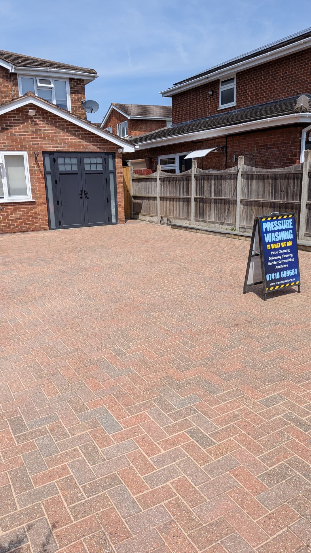 Freshly cleaned block paving driveway in Oxfordshire with Power Wash Pro signage